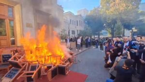 Opposition members set fire to chairs in the courtyard of Albania’s Parliament